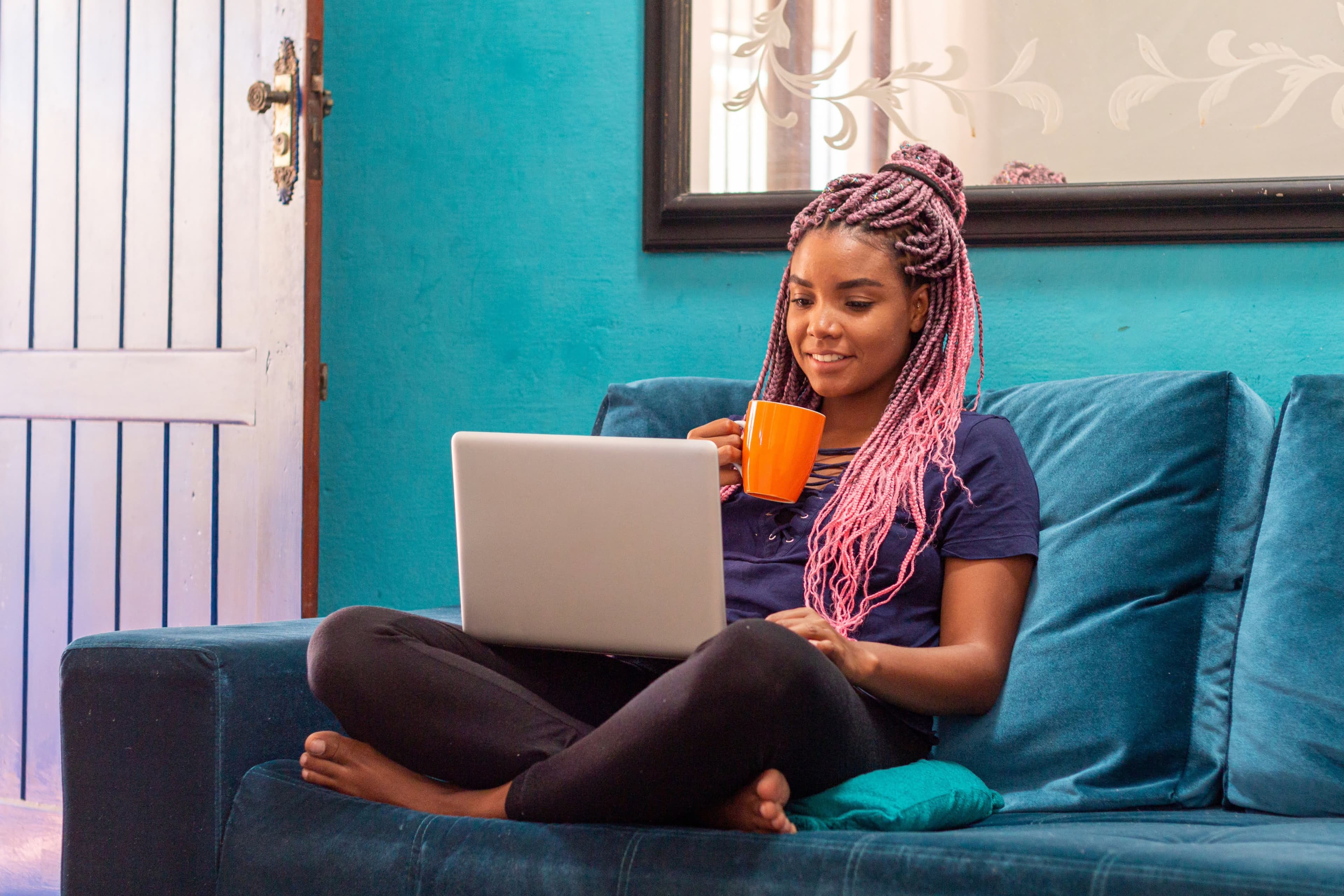 Woman working on laptop with coffee